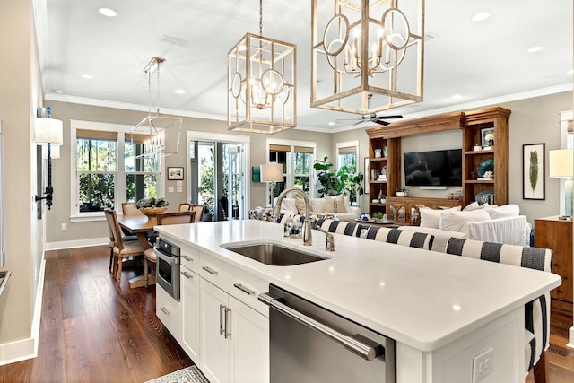 kitchen with dark wood-style floors, dishwasher, crown molding, and a sink