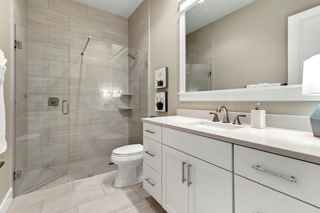 full bath featuring a shower stall, toilet, and vanity