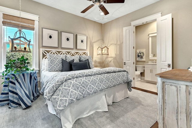 bedroom featuring a ceiling fan and ensuite bathroom