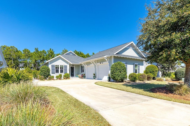 ranch-style home with an attached garage, driveway, and a front lawn