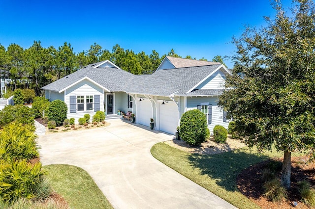 ranch-style house featuring concrete driveway, an attached garage, and a shingled roof