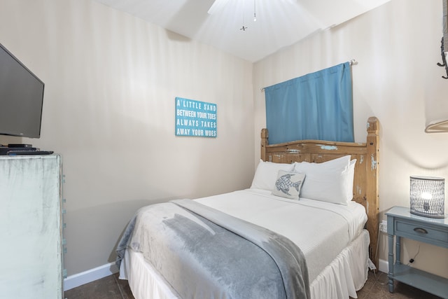 bedroom featuring ceiling fan and baseboards