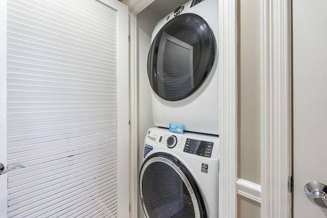 laundry area with stacked washer and clothes dryer and laundry area