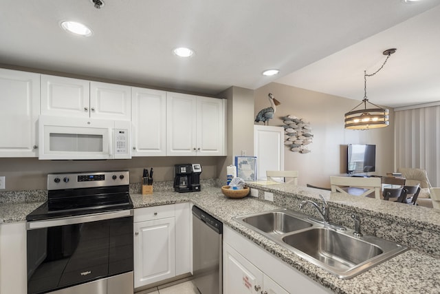 kitchen with appliances with stainless steel finishes, recessed lighting, white cabinets, and a sink