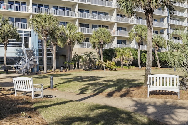 surrounding community with a yard and stairway