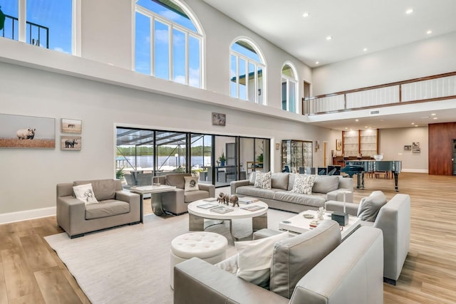 living area with recessed lighting, wood finished floors, and baseboards