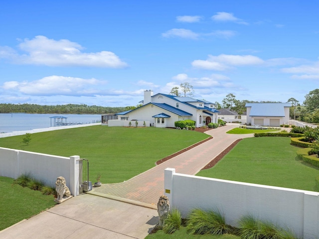 view of yard with a fenced front yard and a water view