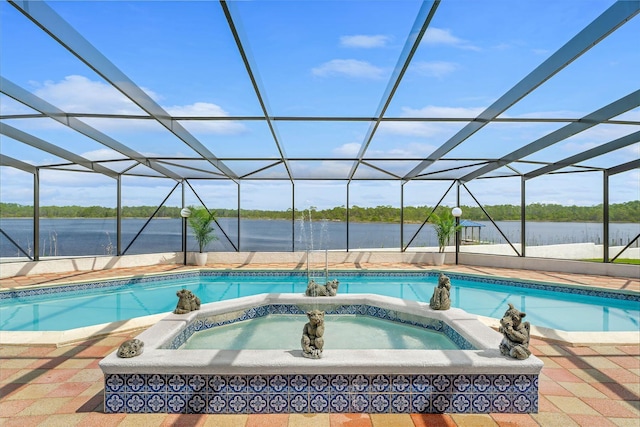 outdoor pool featuring a patio area, an in ground hot tub, a water view, and a lanai