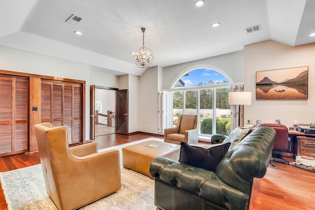 living room featuring light wood finished floors, recessed lighting, visible vents, and an inviting chandelier