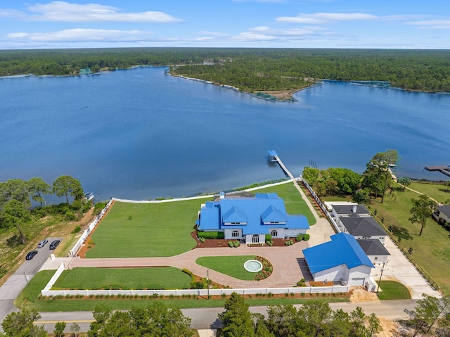 drone / aerial view featuring a water view and a wooded view