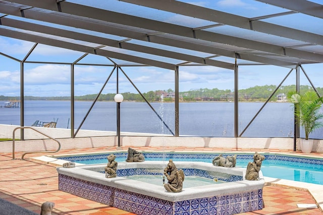 pool featuring a water view, glass enclosure, and a patio area