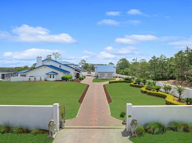 exterior space featuring a fenced front yard, a gate, and a front lawn