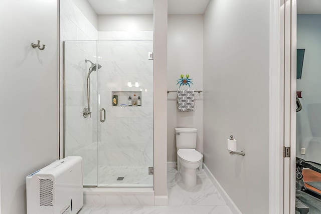 bathroom with toilet, marble finish floor, a shower stall, and baseboards