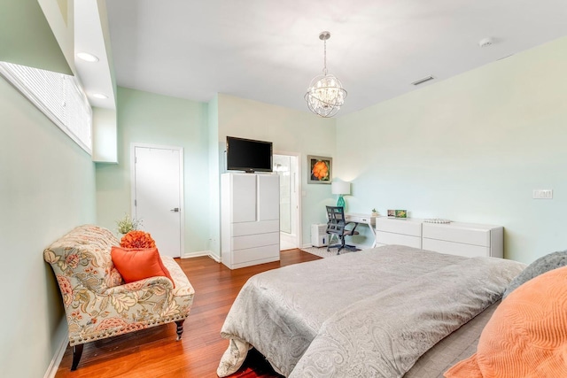 bedroom featuring a chandelier, recessed lighting, wood finished floors, visible vents, and baseboards