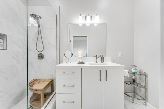 full bathroom with vanity and a marble finish shower