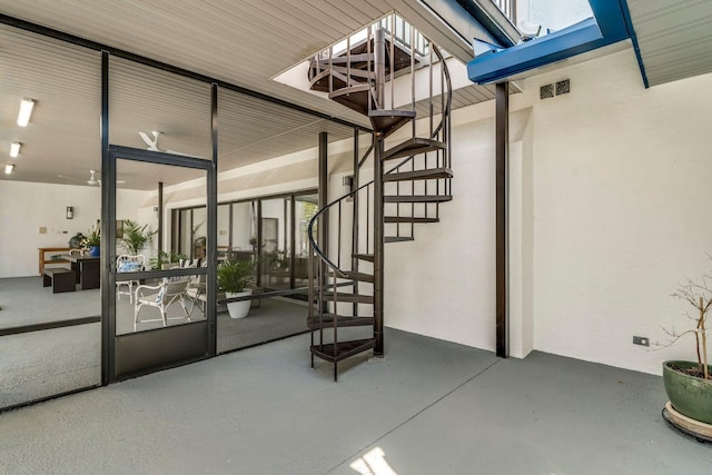 entrance to property featuring a patio and stucco siding