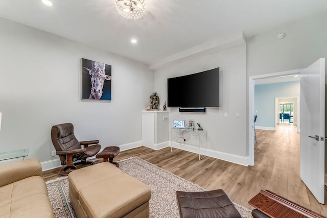 living area with light wood-style floors, recessed lighting, and baseboards