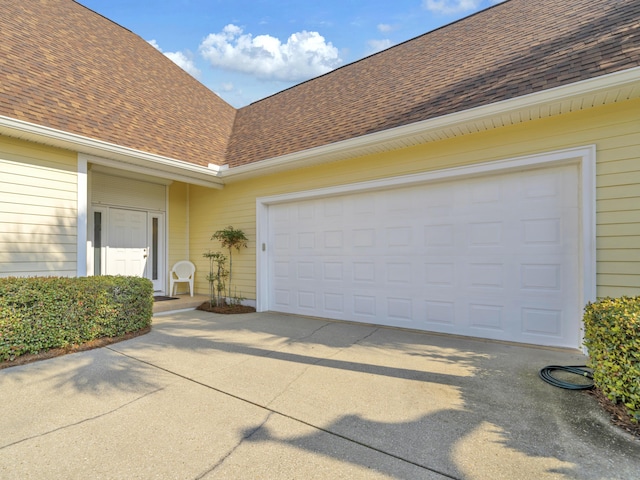 garage featuring concrete driveway