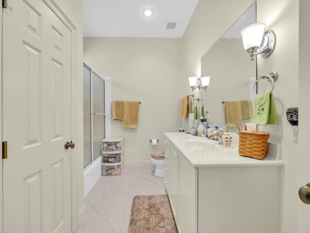 full bath featuring baseboards, toilet, tile patterned flooring, combined bath / shower with glass door, and vanity