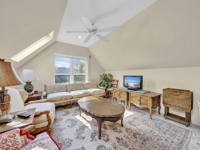 living room with ceiling fan and lofted ceiling with skylight