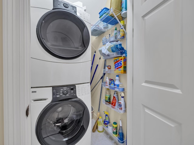 clothes washing area with stacked washer / drying machine and laundry area