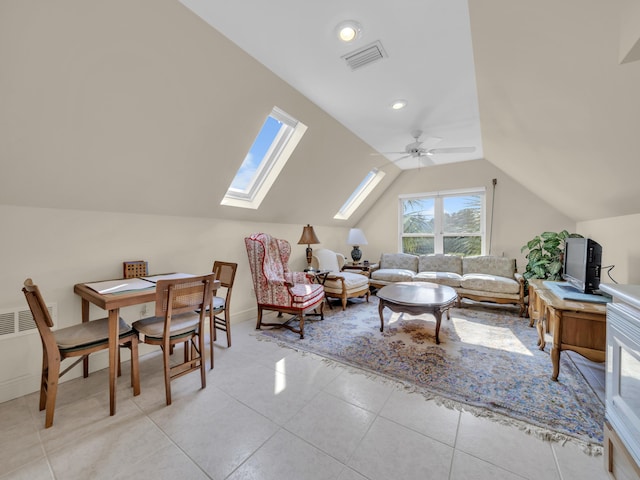 living area with light tile patterned floors, ceiling fan, visible vents, and vaulted ceiling