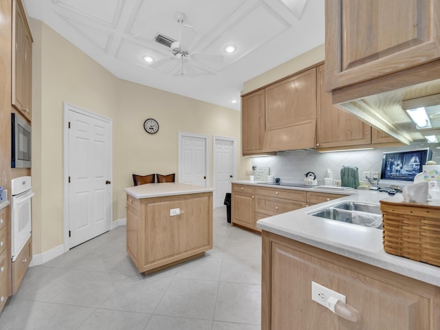 kitchen with light countertops, oven, visible vents, and a sink