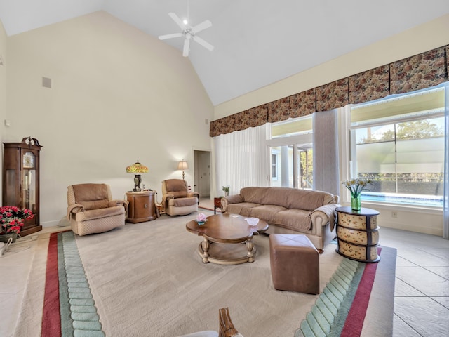 tiled living area with ceiling fan and high vaulted ceiling