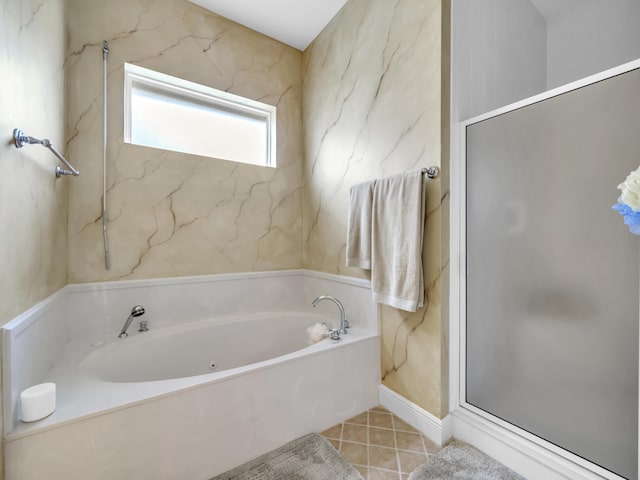 bathroom featuring a garden tub, tile patterned flooring, and a shower stall