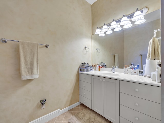 bathroom with tile patterned flooring, vanity, and baseboards