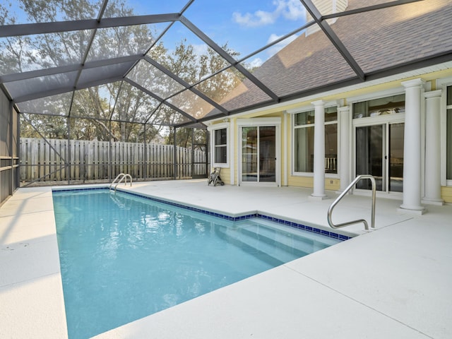 view of swimming pool with a fenced in pool, glass enclosure, a fenced backyard, and a patio