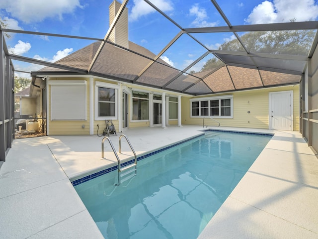 outdoor pool featuring a lanai and a patio area