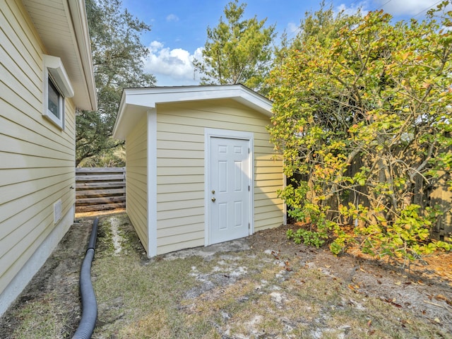 view of shed with fence