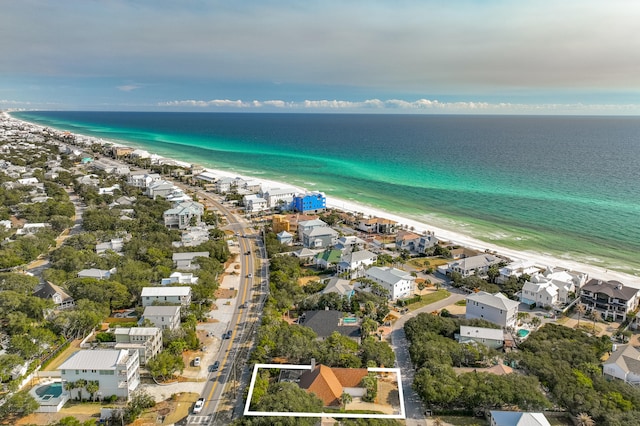 drone / aerial view with a beach view, a residential view, and a water view