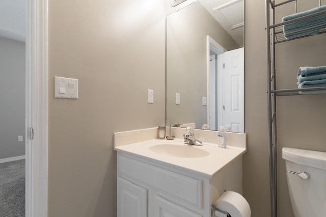 half bathroom with toilet and vanity