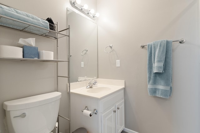 half bathroom with toilet and vanity