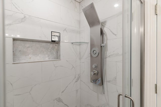 bathroom with a marble finish shower