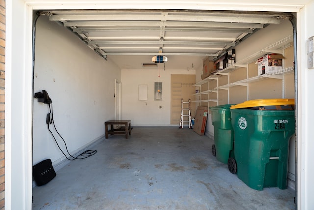 garage featuring electric panel and a garage door opener