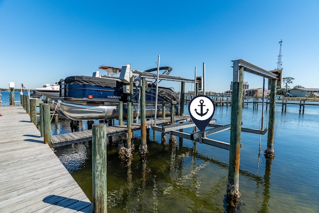 dock area with boat lift and a water view