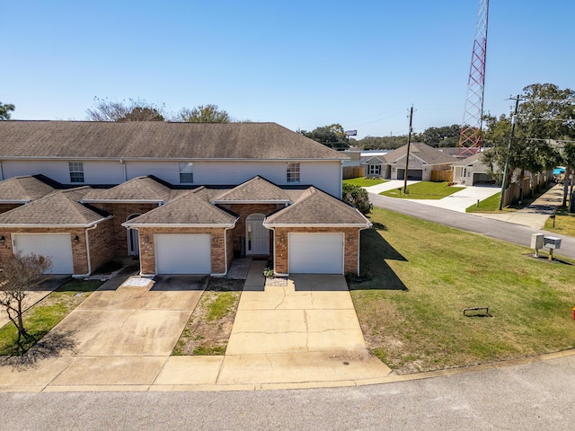 view of front of property featuring brick siding, concrete driveway, a front yard, and a shingled roof