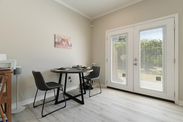 dining space featuring light wood-style flooring, french doors, baseboards, and ornamental molding