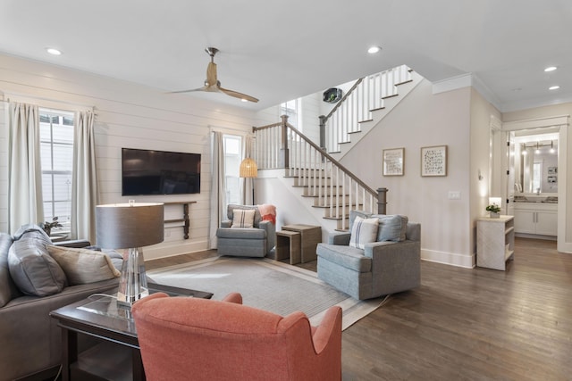 living area featuring baseboards, ceiling fan, stairway, wood finished floors, and recessed lighting