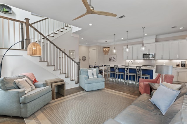 living room with stairs, visible vents, a ceiling fan, and recessed lighting