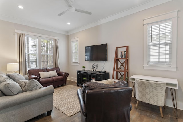 living area with dark wood finished floors, recessed lighting, ornamental molding, a ceiling fan, and baseboards