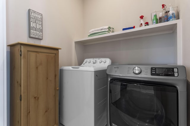 laundry area featuring independent washer and dryer and cabinet space