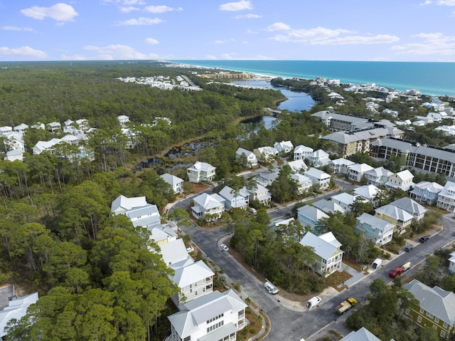 drone / aerial view featuring a water view, a residential view, and a view of trees