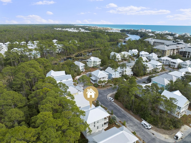 aerial view with a water view, a forest view, and a residential view