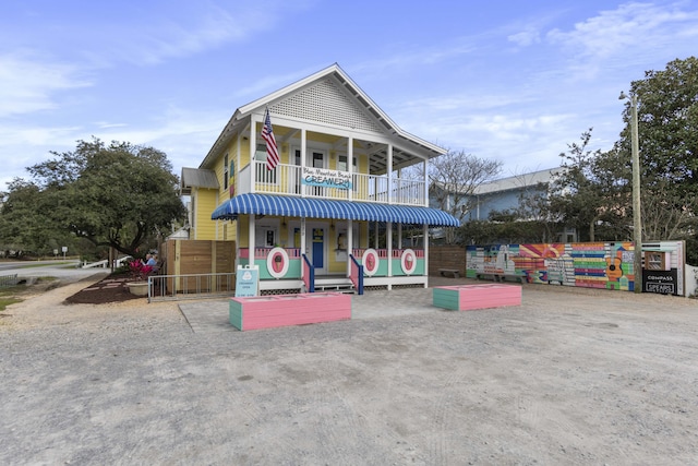 view of front of house featuring a balcony