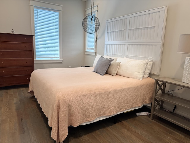 bedroom with dark wood-style floors