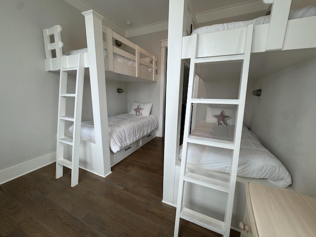 bedroom with dark wood-style flooring and baseboards